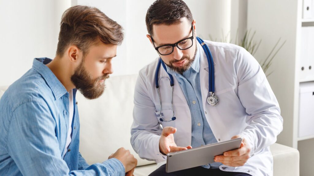 HPV beim Mann: Arzt erklärt einem männlichen Patienten den Befund